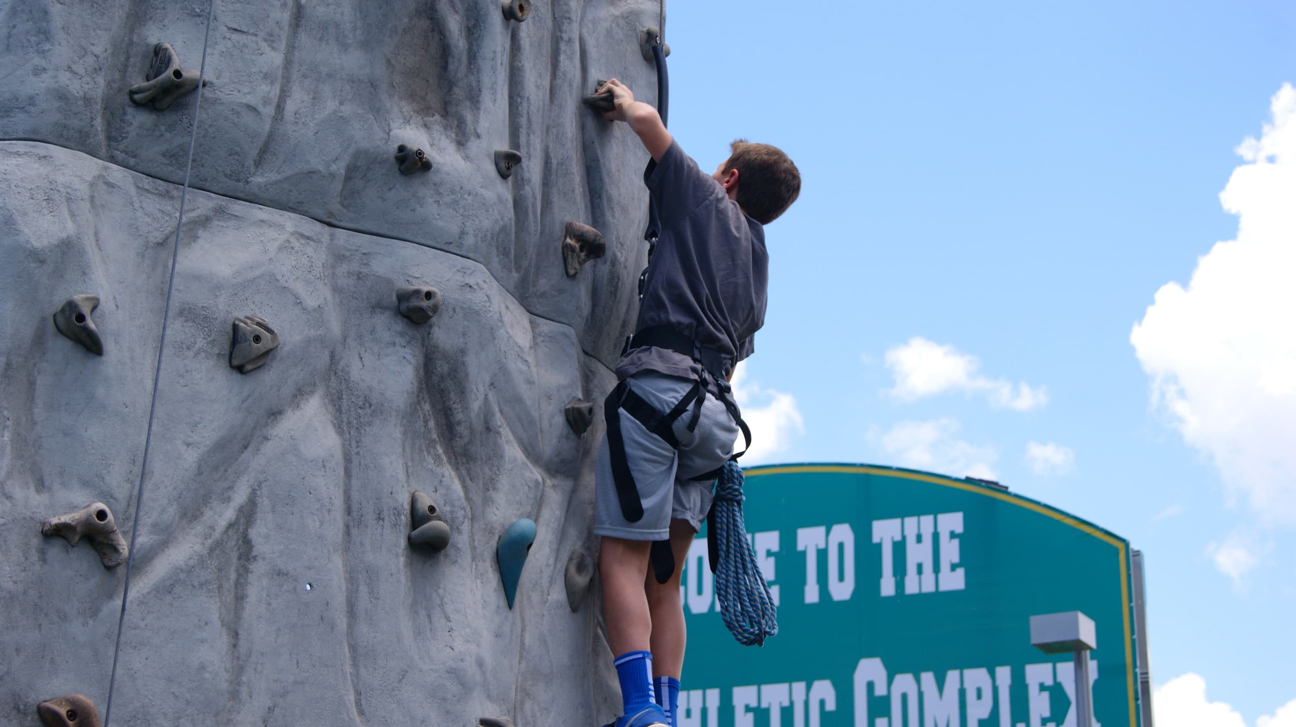 Summer camper on a climbing wall