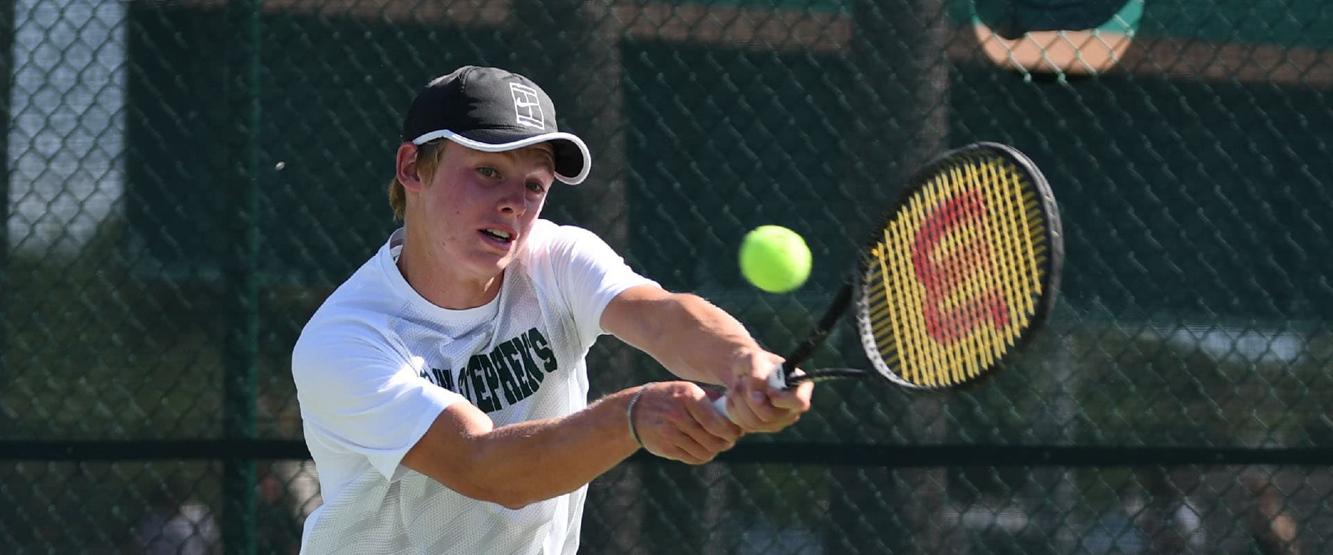 Student playing tennis