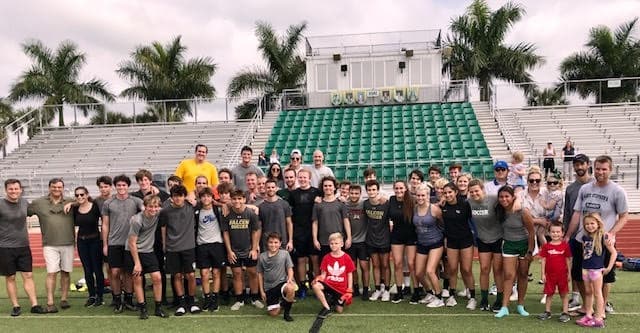 Alumni in front of stands