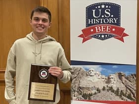 Jackson Nealis holding his US History Bee award